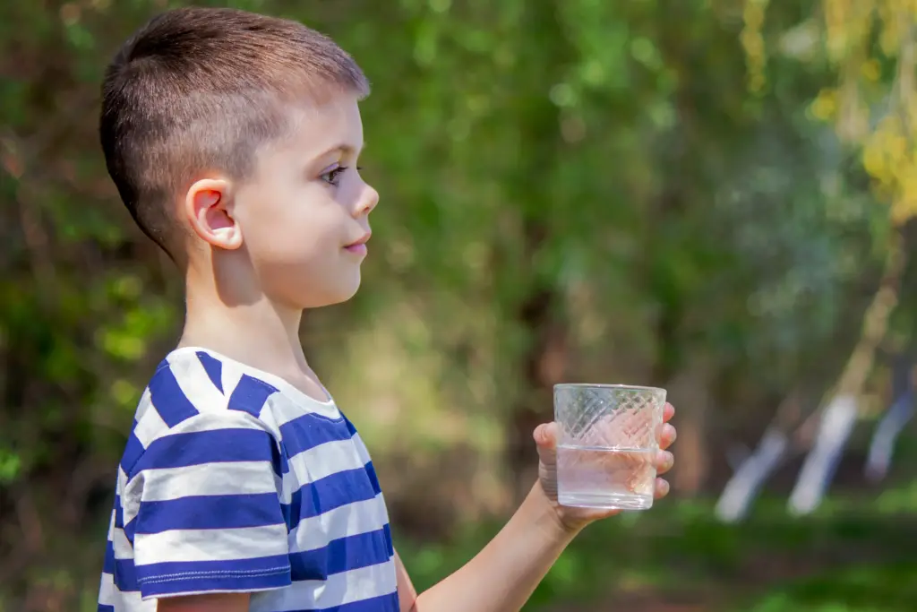 A boy drinking a glass of water