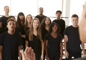 A group of young people singing.